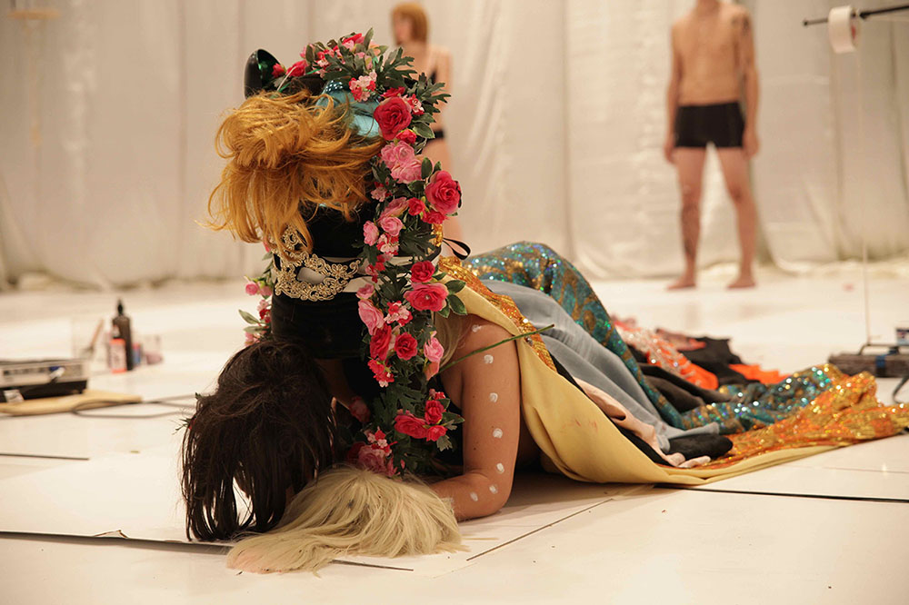 Paradise Now — performers, flowers and costumes on stage